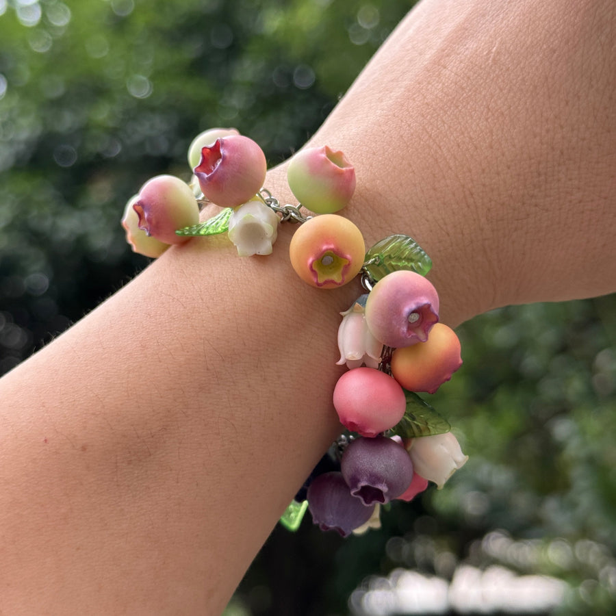 FRULEA blueberry bracelet with tiny leaves and flowers worn on a wrist